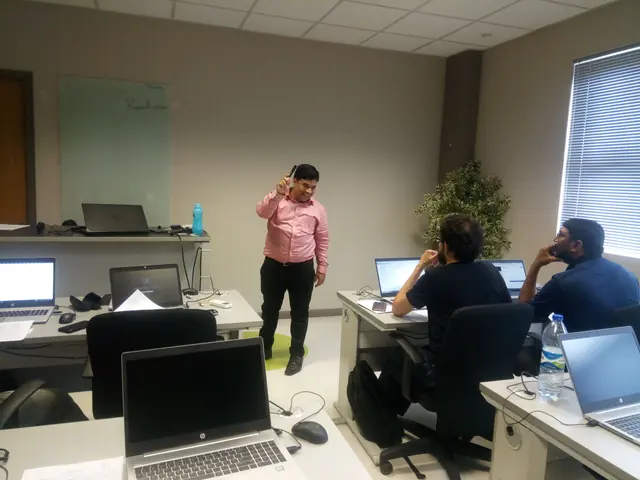 Teaching a small corporate group beside their laptops